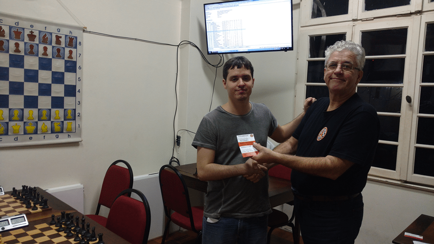 Leo Ramos Simões recebendo de Álvaro Frota o diploma de Terceiro Lugar Feral do Rápido FIDE de Junho